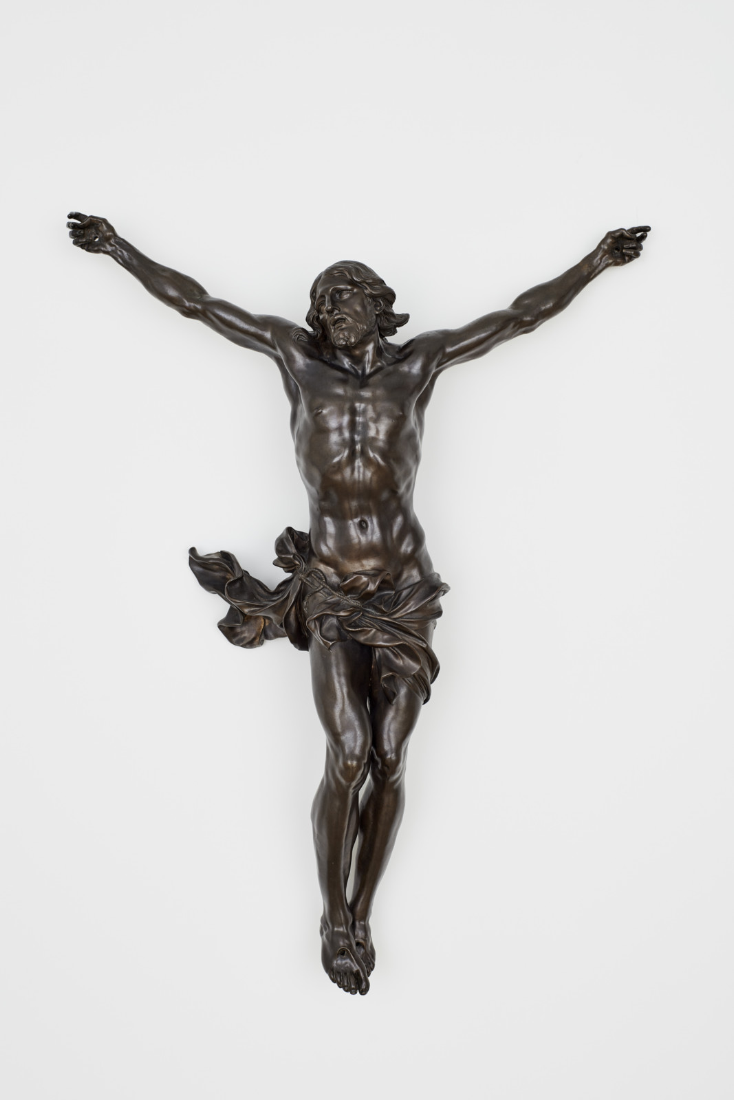 Statue of crucified Christ hanging on gallery wall