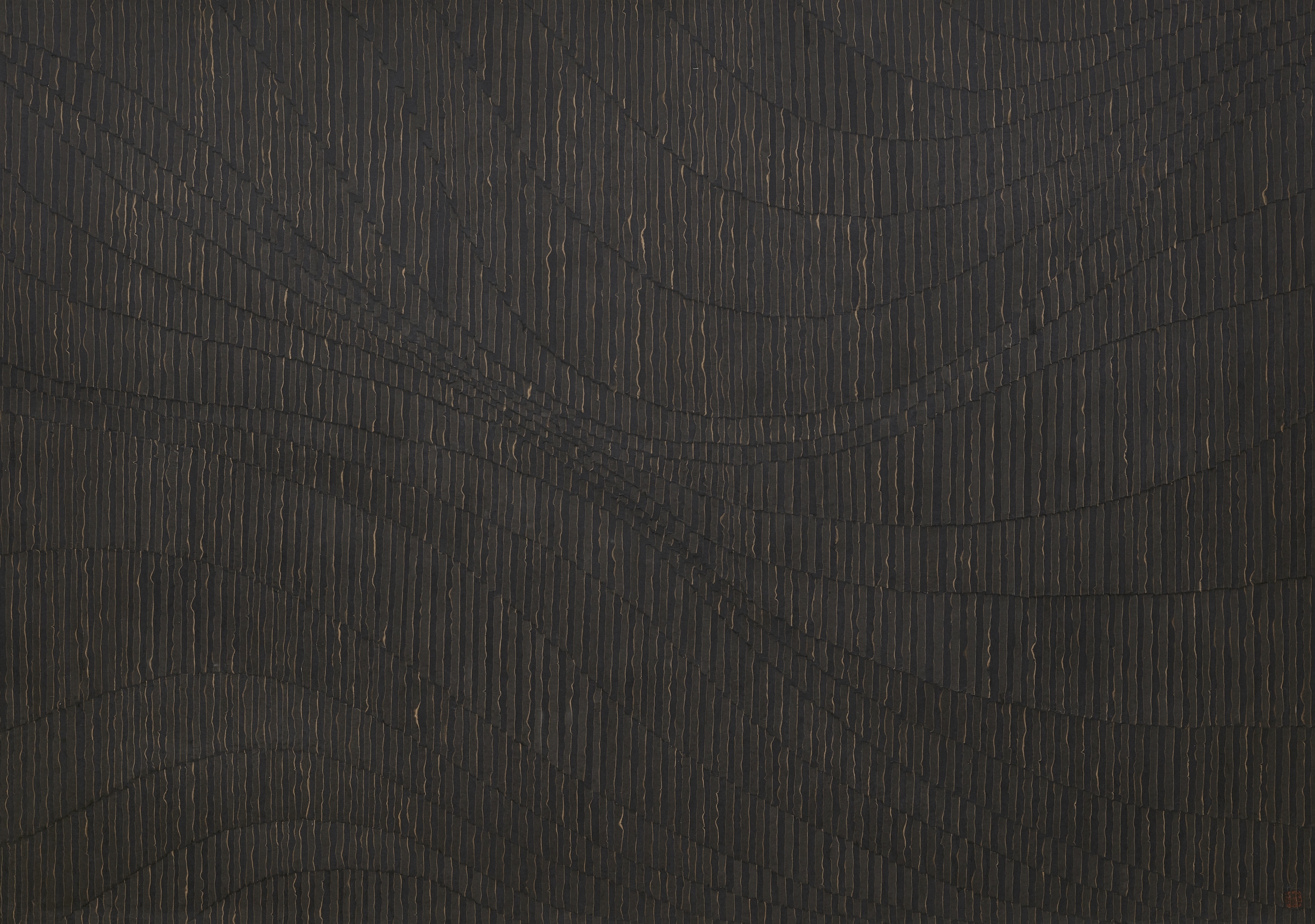 Strips of black and brown burned paper in a series of patterned lines.