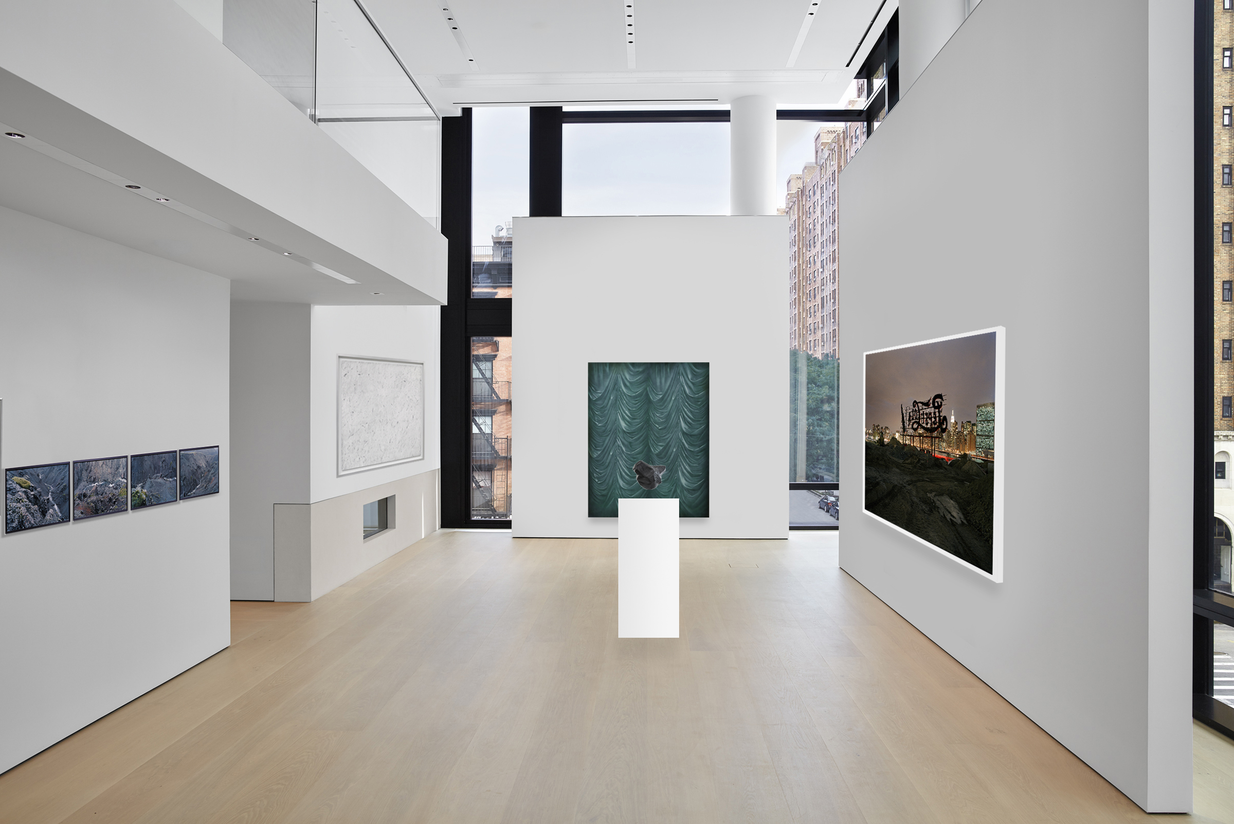Rendering of a gallery space with artworks on floating white walls and a sculpture in the center...