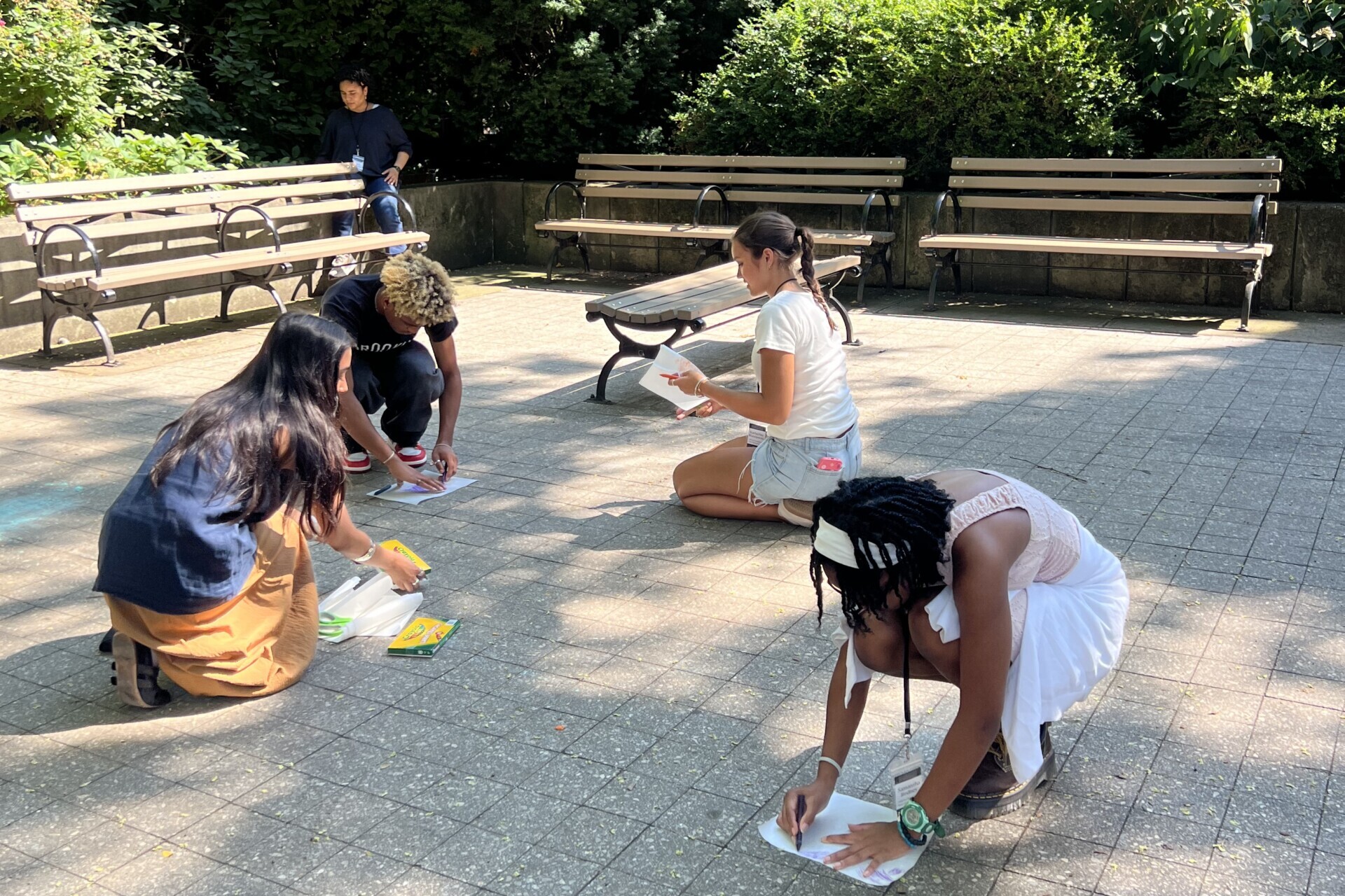 Students drawing outdoors in a park