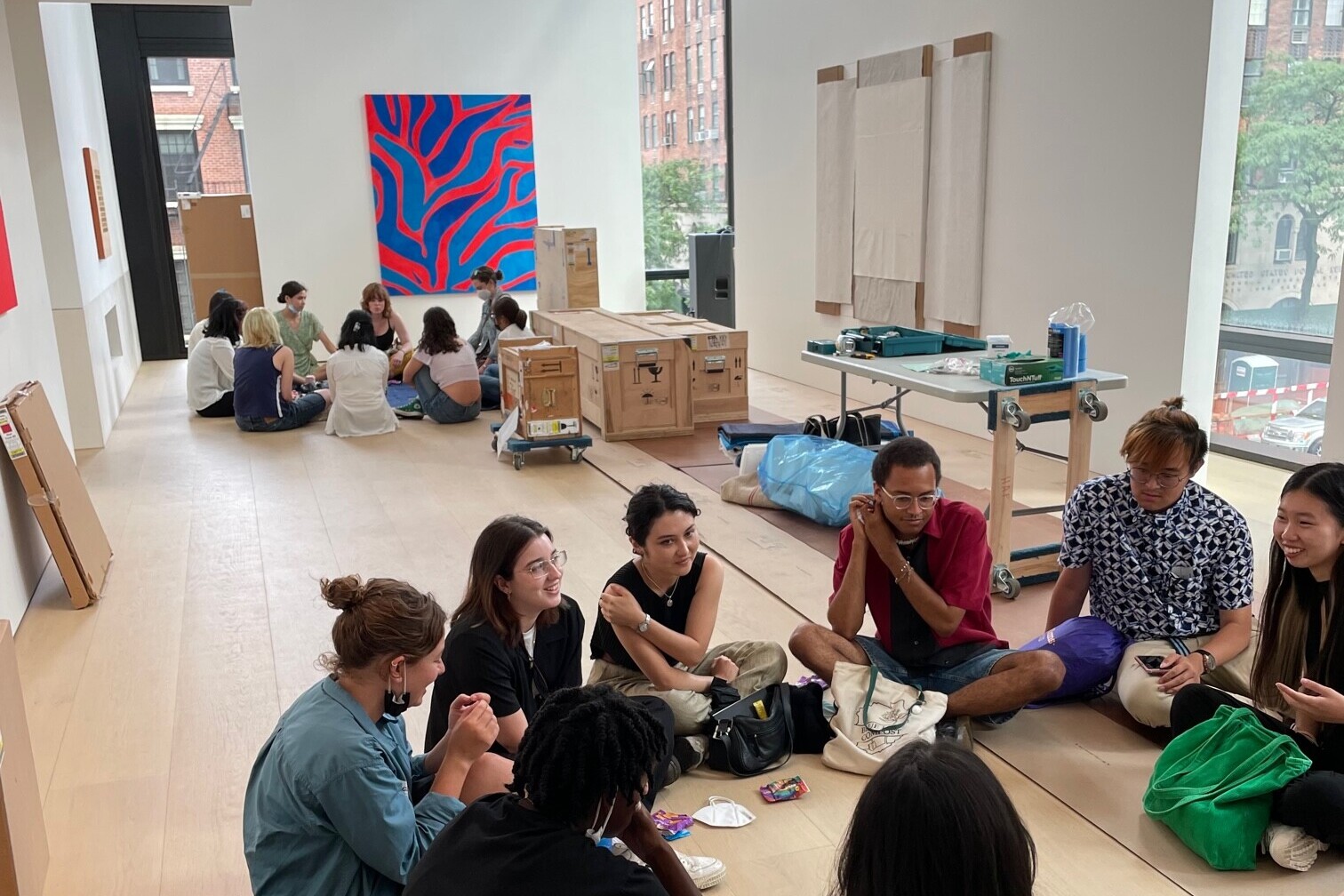Student sitting in two circles in gallery during installation